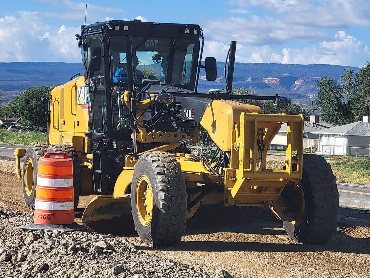 140 motor grader grading a residential road